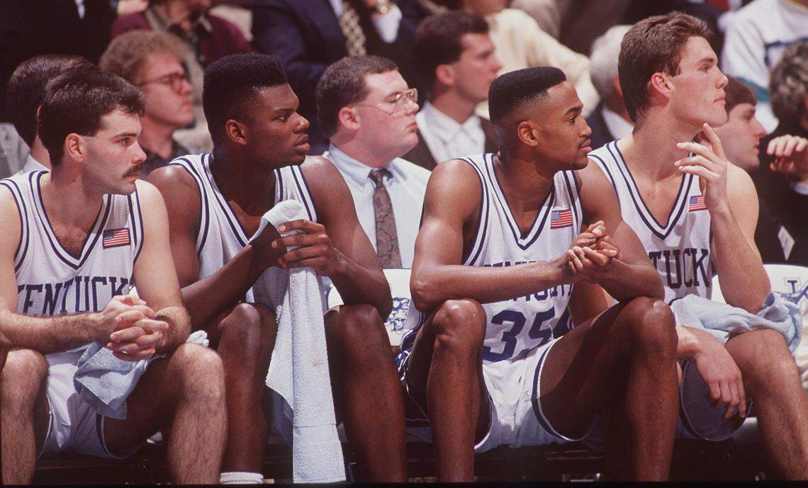 Reggie Hanson (35) sat on the UK bench with teammates, from left, Richie Farmer, Jamal Mashburn and Deron Feldhaus during a game in 1991.
