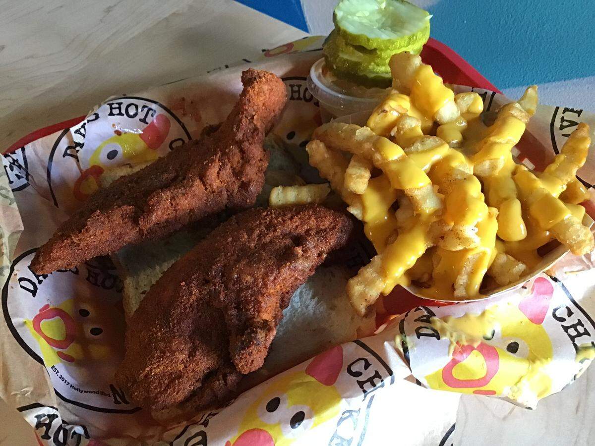 Dave’s Hot Chicken also serves chicken tenders with the spice level you specify. Sides include fries, which can come as cheese fries. Everything comes with Dave’s sauce and with pickles.