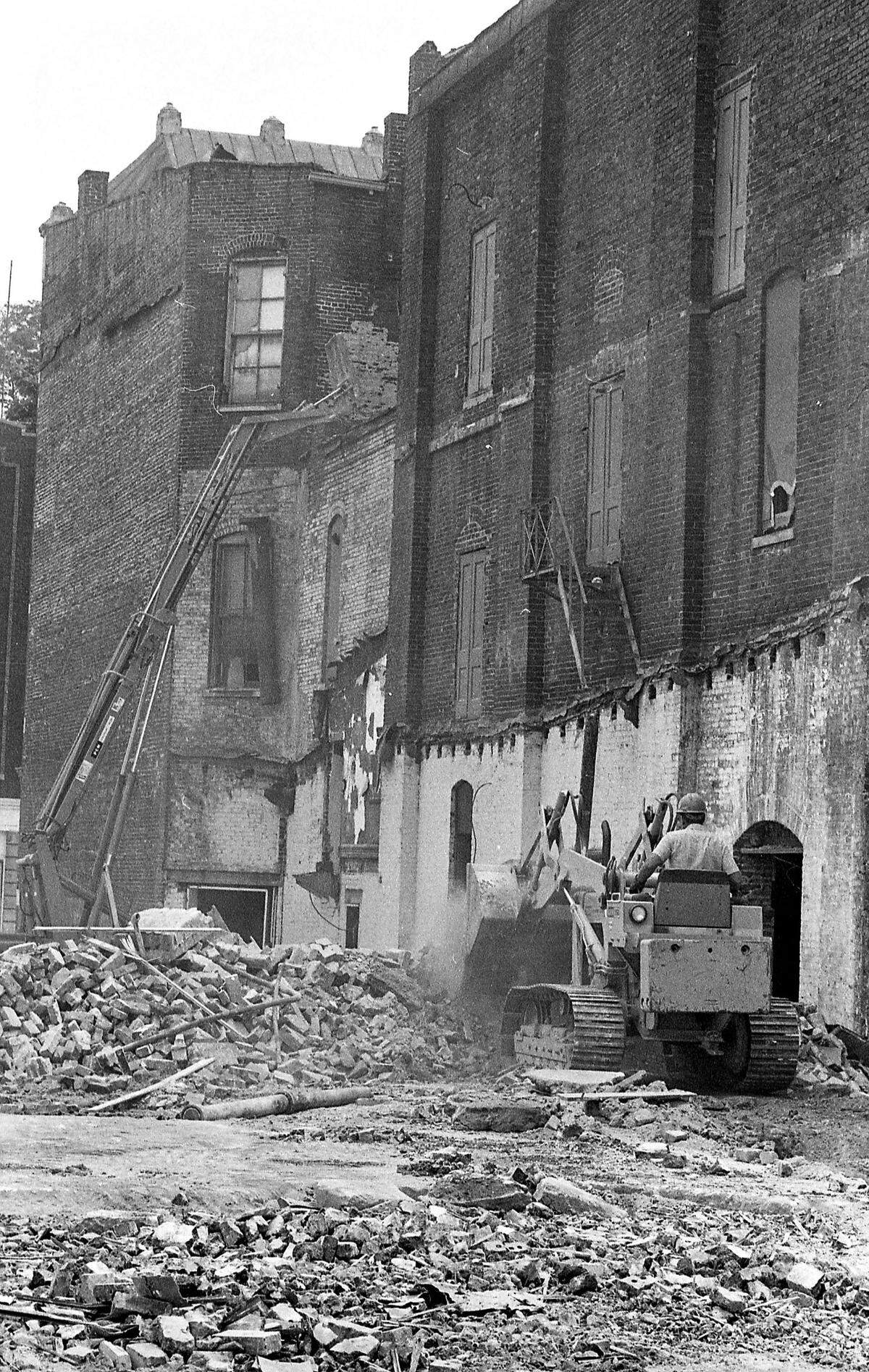 A worker with Horn and Williams Excavating Co. rides a bulldozer Oct. 10, 1974 as the restoration of the Lexington Opera House continues in downtown Lexington. The historic theatre at the corner of West Short Street and South Broadway needed a renovation after high winds demolished the roof in 1973. Private and public fund drives started to save the theatre and ultimately it became part of the Lexington Center complex that included the new Rupp Arena and convention center that opened in 1976. Restoration of the 19th century structure cost $4 million. It reopened Friday, May 7, 1976 with a performance by the Lexington Philharmonic and the Lexington Singers.