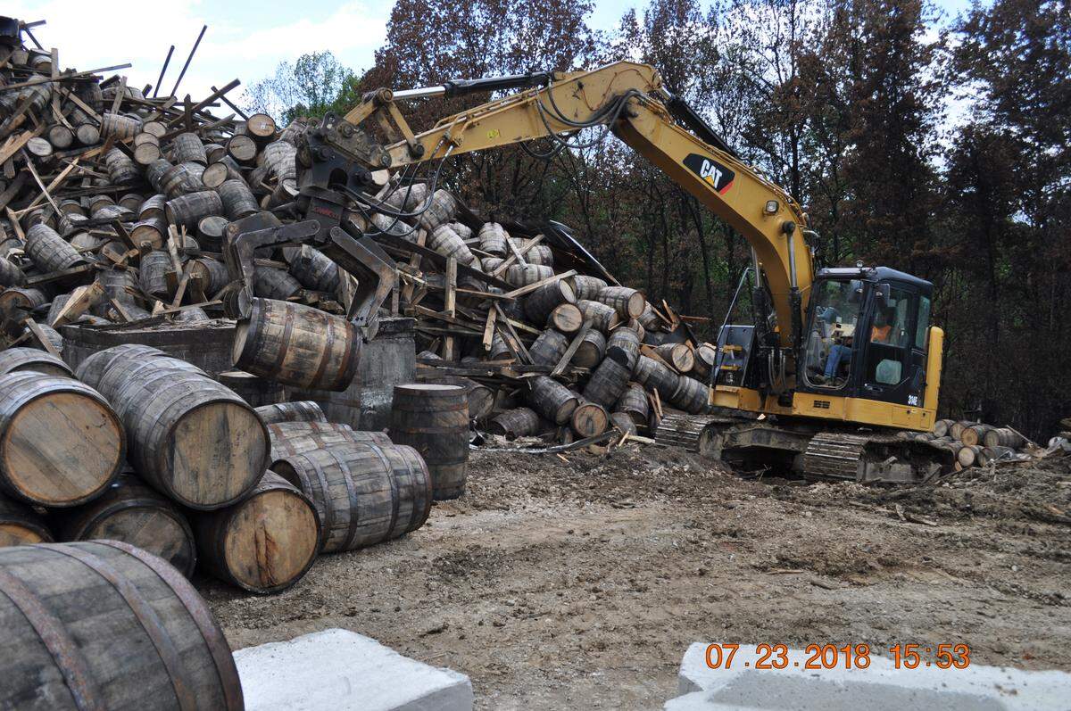 Cranes began recovering barrels, one at a time, in early July. The cleanup is expected to continue for months.