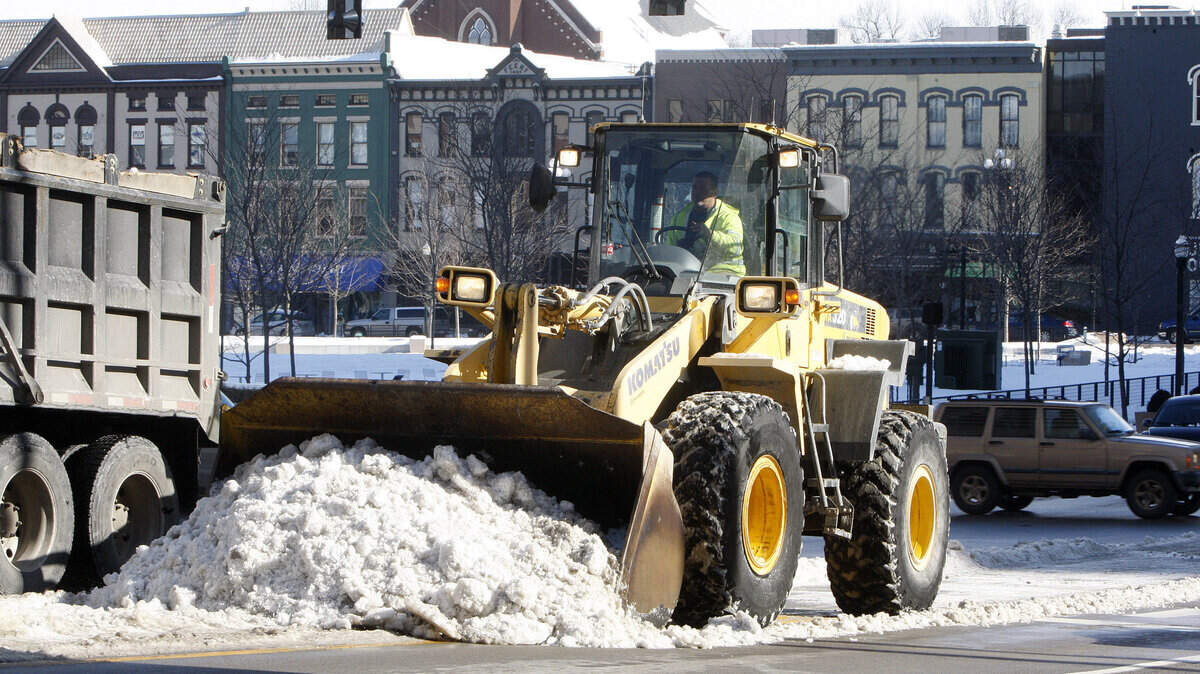 A crew from Bluegrass Contracting Corp. cleared snow in advance of what was expected to be a busy Saturday downtown.