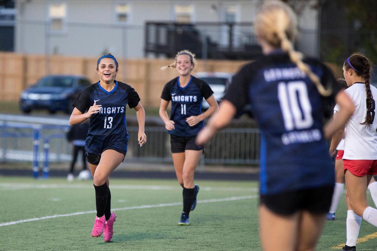 Lexington Catholic’s Mary Martin Hampton (13) and Katherine Truitt (11) celebrate with Joanna Bryant (10) after Bryant scored a goal against Lafayette during the girls’ 43rd District finals at Tates Creek on Oct. 5.