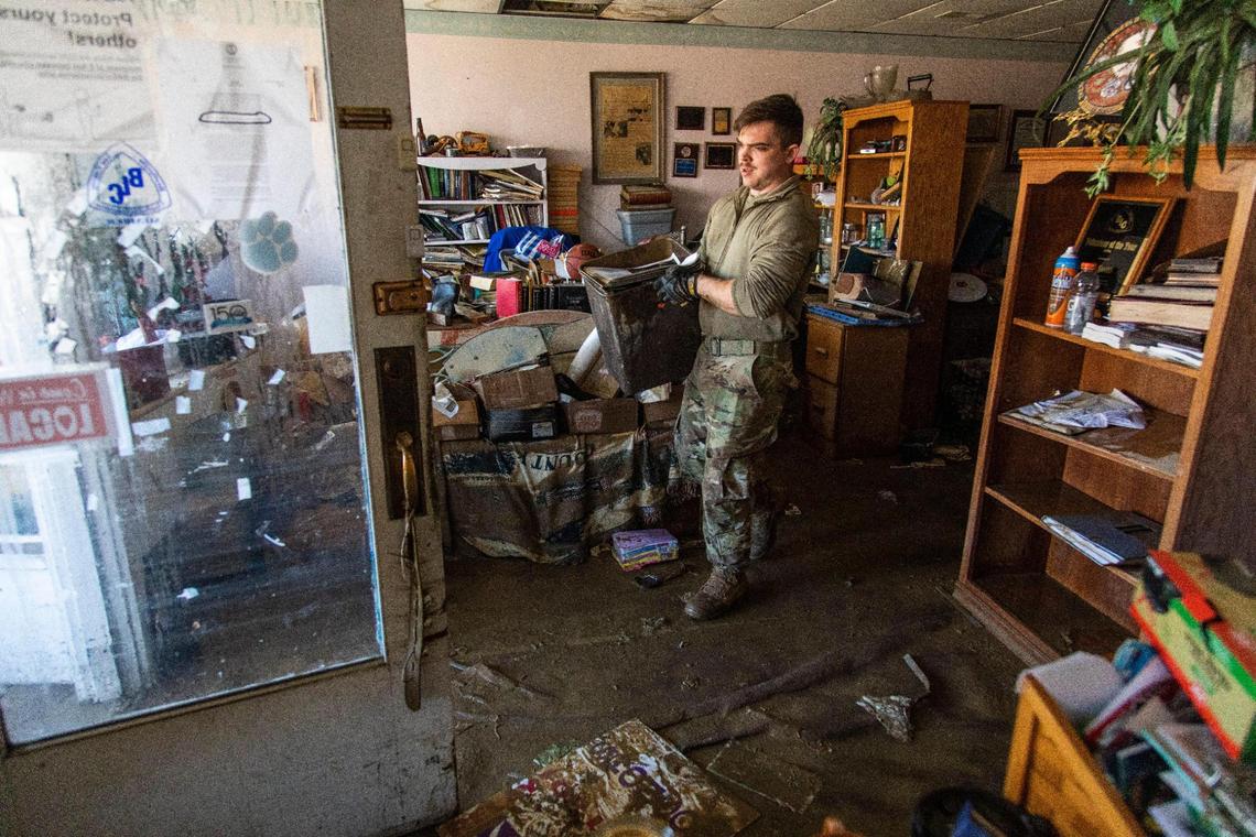 Members of the National Guard help clean out the Three Forks Tradition office after severe flooding in downtown Beattyville, Ky, Wednesday, March 3, 2021. According to Lee County search and rescue member Tyler Phillips close to 60 people have been displaced by the flooding with Beattyville being hit the hardest in the county.