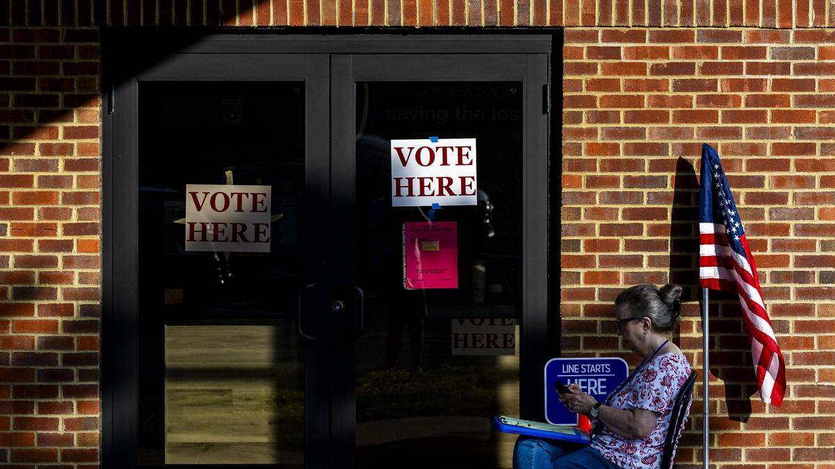 Precinct worker Karen Devin sits outside Man o’ War Church as voters cast their ballots inside during the 2026 primary election, May 19, 2026, in Lexington, Ky. “We haven't been terribly busy yet,” said Devin. Voters went the polls on primary election day across Kentucky to decide who will be on the ballot in November for major races across the commonwealth.