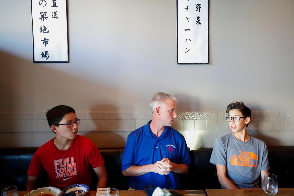 Jonas Tyler, 15, left, eats dinner with family members Chris Tyler, center, and Zeke Tyler 14, all of Lexington, Ky., at Zen Sushi & Sake in Lexington, Friday July 26, 2019. Over the past year the Tyler family have been eating “alphabet dinners” choosing restaurants from a-z staring with Asian Wind and ending with Zen Sushi & Sake.