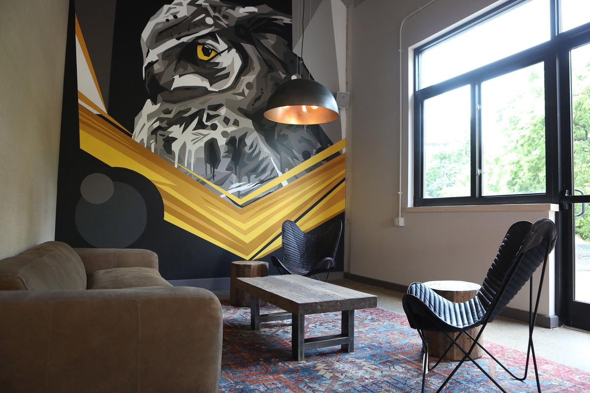 Seating area with owl mural at Wise Bird Cider Co., which opens June 7 in the Pepper Distillery District.