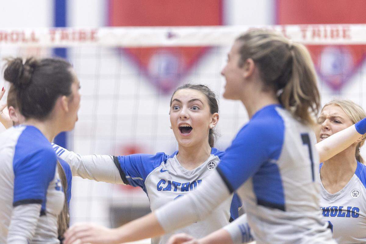 Lexington Catholic's Ella Blackburn (11), center, reacts with her teammates after winning a point in their 11th Region Tournament championship win over Paul Laurence Dunbar last season. The Knights are ranked No. 9 in the state this preseason.