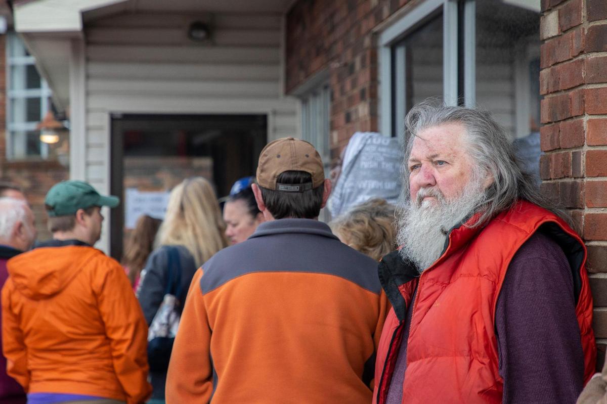 Gary Clark, right, of Lexington waits in a line for Max’s Loudon Square Buffet in Lexington, Ky., to open on its final day on Friday, April 8, 2022.