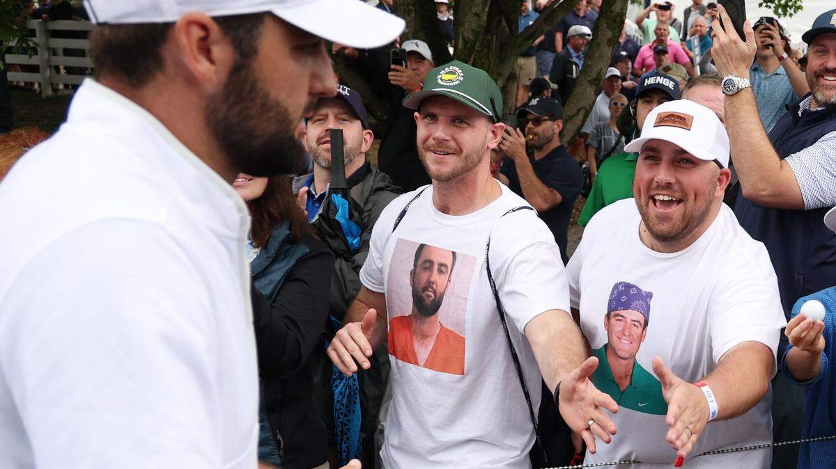 Scottie Scheffler, left, shakes hands with fans wearing Scottie Scheffler t-shirts as he walks off the 9th green during the second round of the PGA Championship at Valhalla Golf Club on Friday, May 17, 2024, in Louisville, Kentucky. (Patrick Smith/Getty Images/TNS)