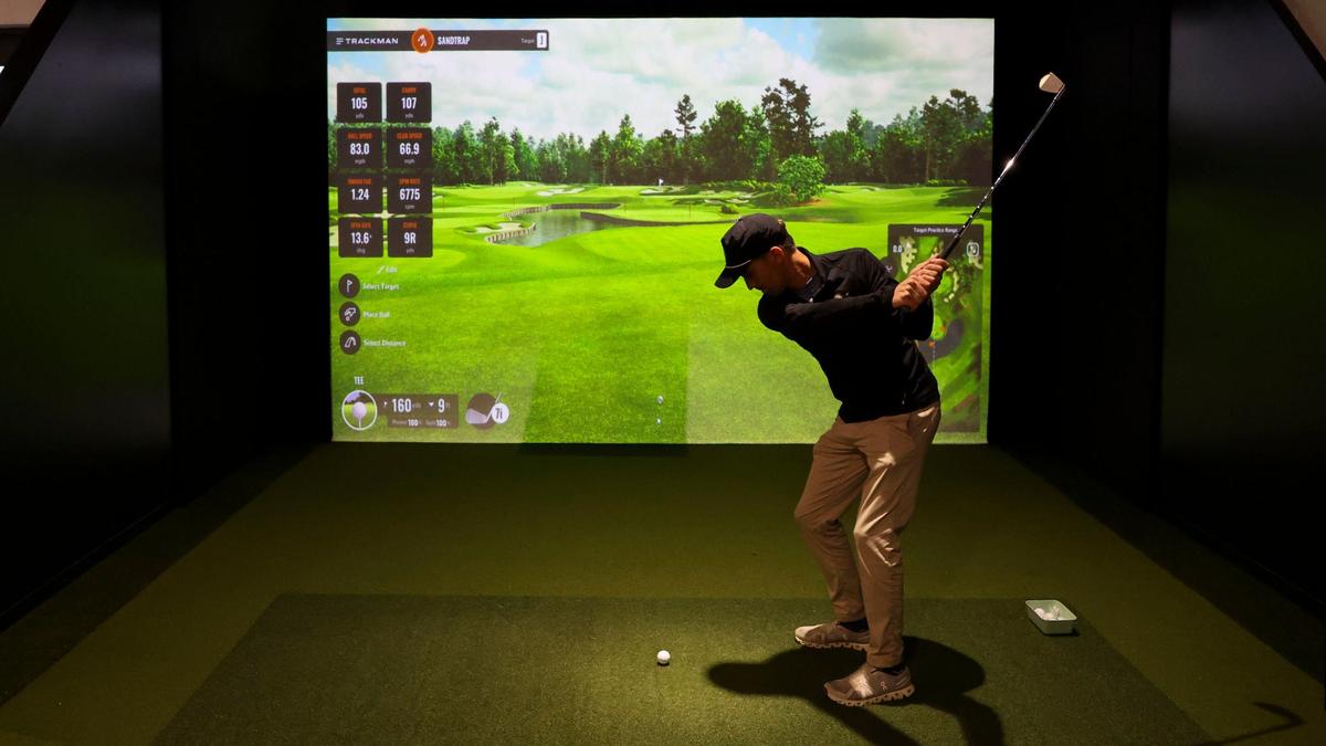 Eric Bivins, co-owner of the Sand Trap golf simulator facility, plays one of the 333 virtual courses, Thursday Sept. 26, 2024 in Lexington, Ky. The new Lexington business has three golf simulators, each with top courses, analytics, games and more.