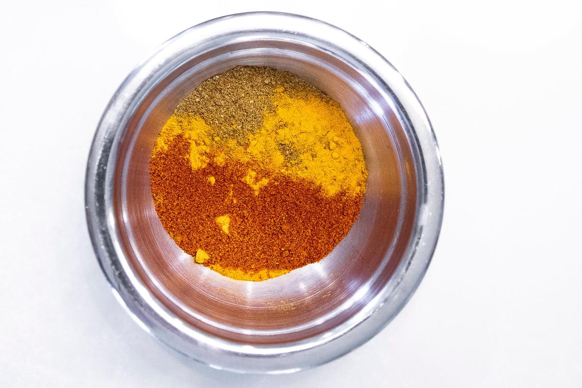 Samantha Fore prepares spices for a mango curry.