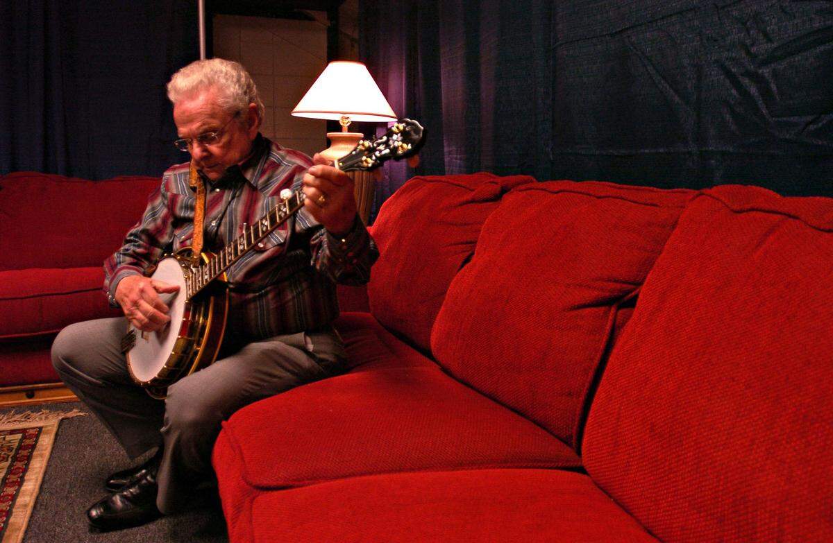 Bluegrass artist Ralph Stanley picks on his banjo in his dressing room backstage May 7, 2004 before the Great High Mountain tour hits Cincinnati.