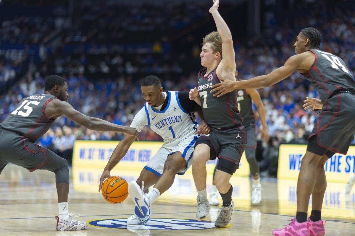 Kentucky guard Lamont Butler (1) drives the ball as Oklahoma guards Kobe Elvis (1) and Duke Miles (15) defend during their SEC Tournament game at Bridgestone Arena in Nashville, Tennessee.