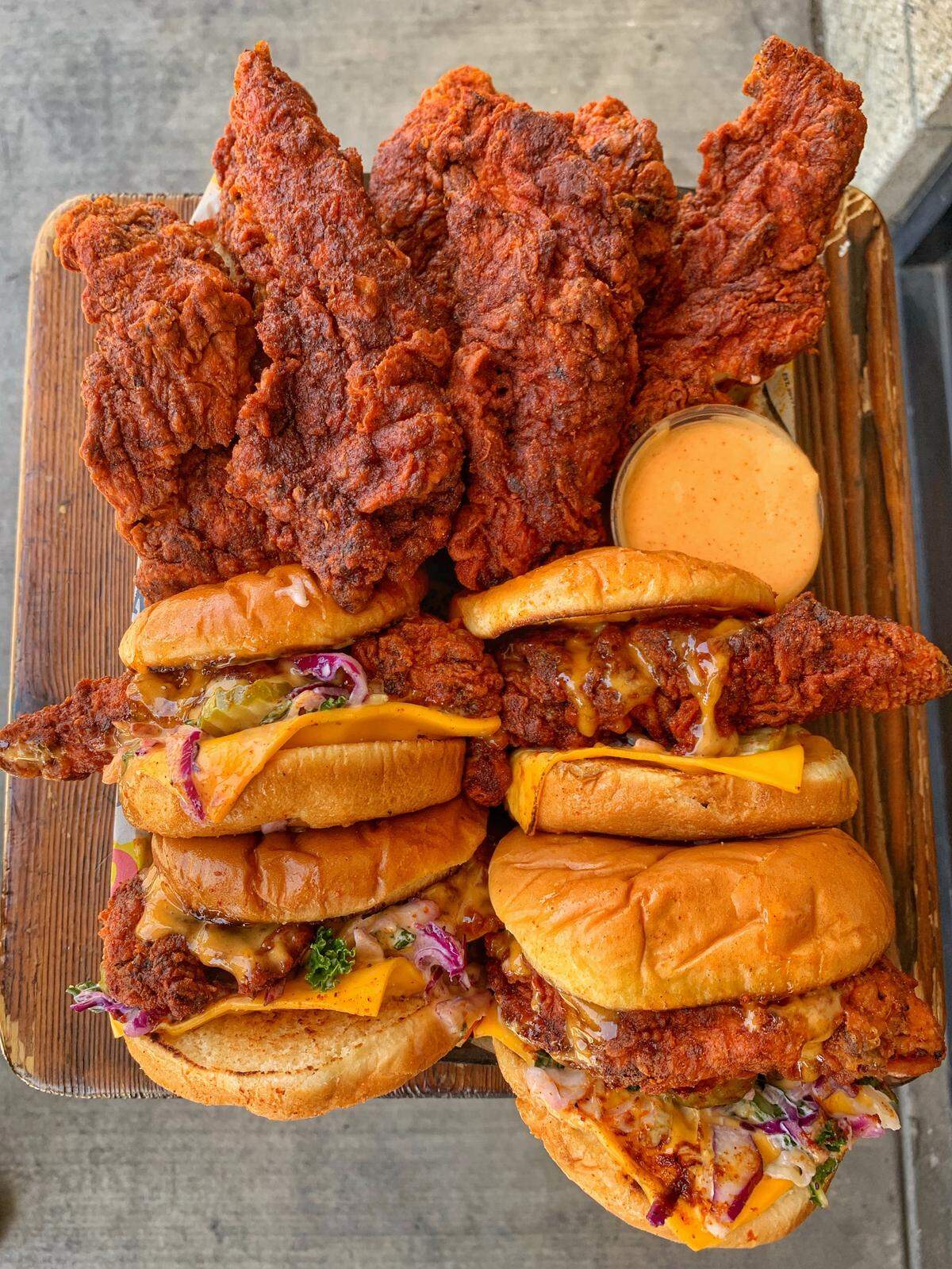 The menu at Dave’s Hot Chicken features sliders and tenders, with heat options ranging from no spice to “reaper.” Comes with slaw and pickle, cheese also available.