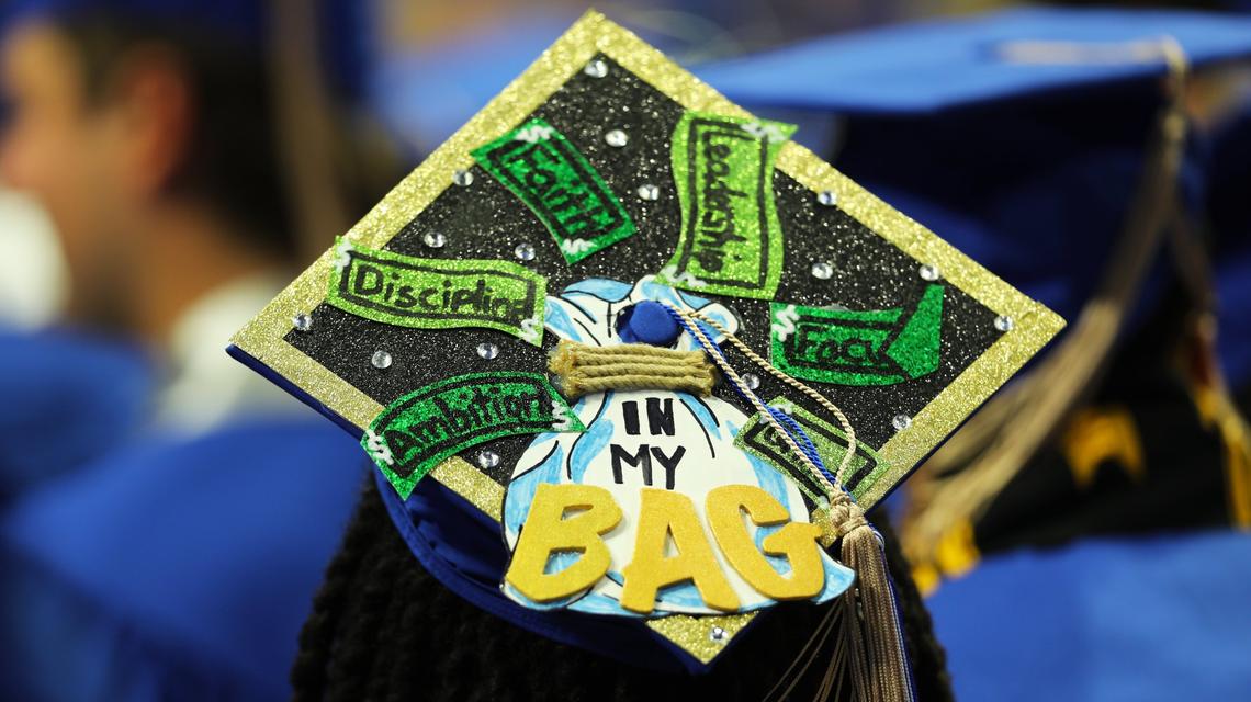 A UK graduate student sports the “In my Bag” decoration on her graduation hat during the first of two UK graduation ceremonies at Central Bank Center on May 9, 2025, in Lexington, Ky.