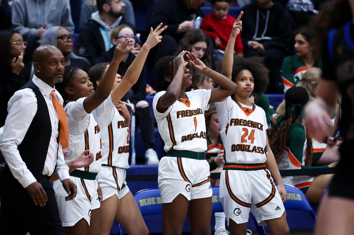 The Frederick Douglass bench celebrates scoring against Henry Clay during the 42nd District Tournament championship game on Friday. Douglass will host Lafayette in Monday’s first round of the 11th Region Tournament.