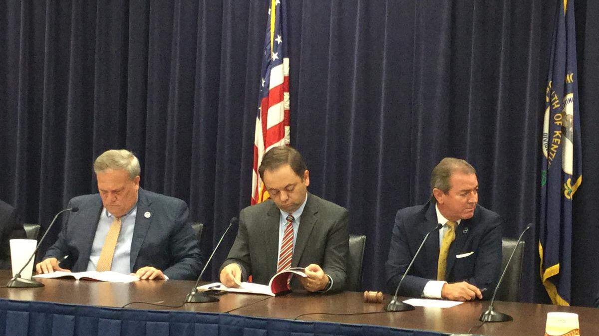 Kentucky Legislative Research Commission Director David Byerman sits between the two men who decided not to renew his contract, Senate President Robert Stivers, left, and House Speaker Pro Tempore David Osborne, at the legislative leadership meeting in Frankfort on Wednesday, Sept. 5, 2018.
