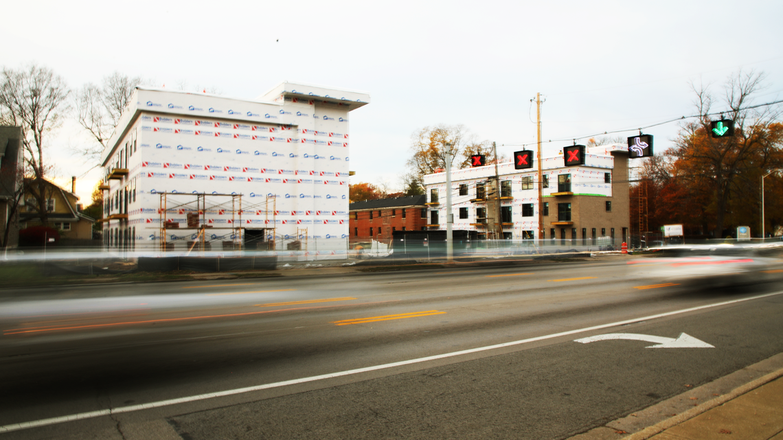 Cars whiz by a 41-unit apartment complex under construction on Nicholasville Road.