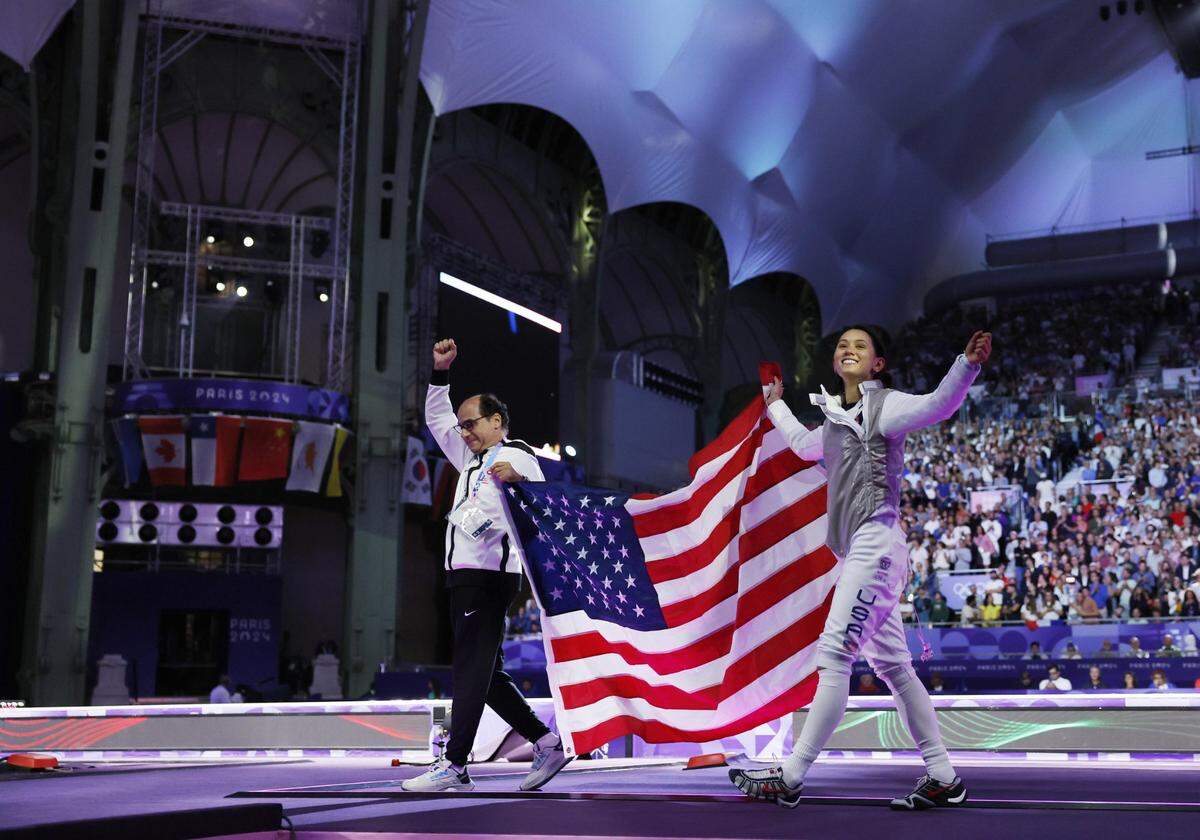Jul 28, 2024; Paris, France;  Lee Kiefer (USA) celebrates with coach Amgad Khazbak after winning the women's foil gold medal bout during the Paris 2024 Olympic Summer Games at Grand Palais. Mandatory Credit: Yukihito Taguchi-USA TODAY Sports