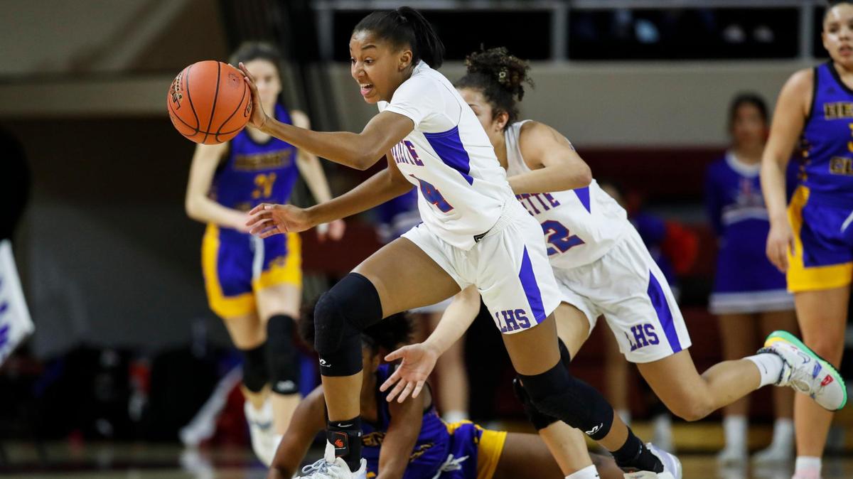 Lafayette’s Anaya Brown (4) steals the ball from Henry Clay’s Ariyanna Sutton (1) during the Girls’ 11th Region Tournament at Eastern Kentucky University last month. Brown was named Lexington’s player of the year in a vote of coaches.