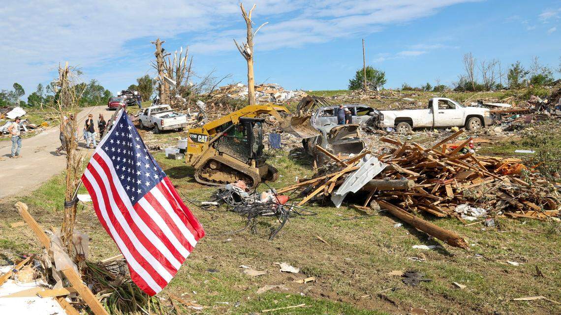 Melvin Brock removes debris in front of the destroyed Sunshine Hills neighborhood home of David and Edwina Wilson, Sunday, May 18, 2025 in London, Ky. Two days earlier, a deadly tornado ripped through the neighborhood destroying homes.