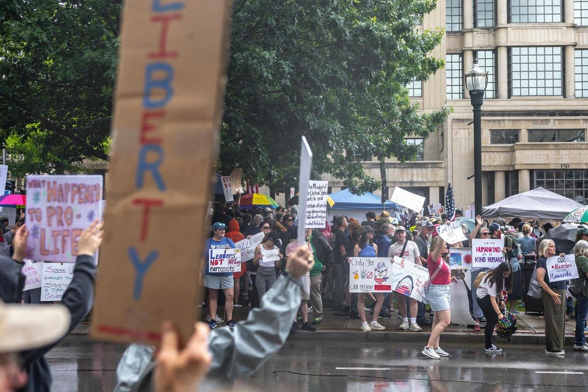Protesters gather in downtown Lexington, Ky., during the “No Kings” protest on Saturday, June 14, 2025.