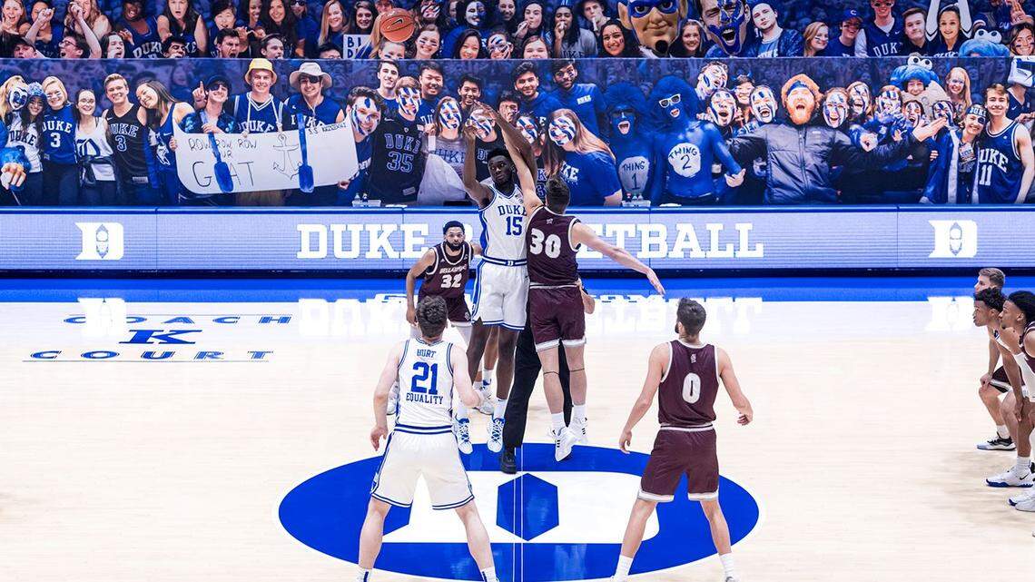 Nick Thelen (30) of Bellarmine tipped things off against Duke’s Mark Williams (15) in the Knights’ NCAA Division I debut at the Blue Devils’ Cameron Indoor Stadium in Durham, N.C., on Friday night.