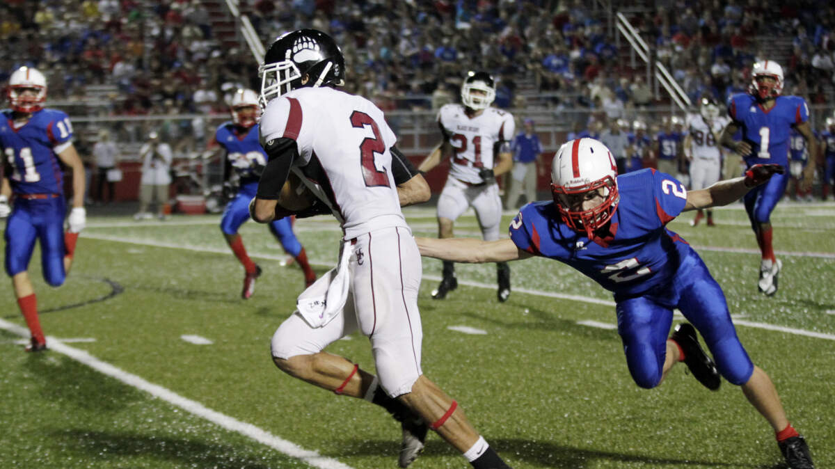 Harlan County's Cole Wilson, center, escaped from Madison Central's Blake Gross during  Saturday's 49-6 rout of the Indians.
