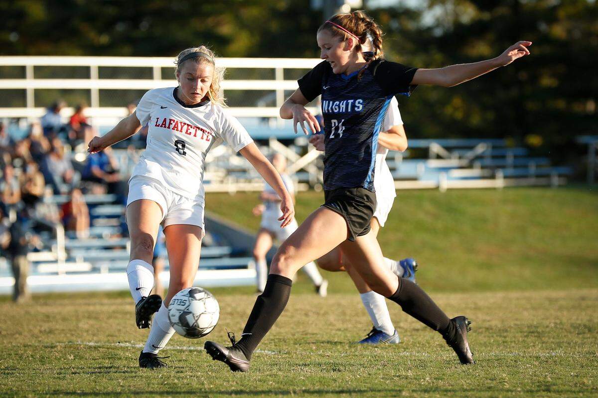 Lafayette’s Sarah Hall (8) and Lexington Catholic’s Emily Scanlon (24) battle for the ball. Scanlon contributed 13 goals and eight assists last season.