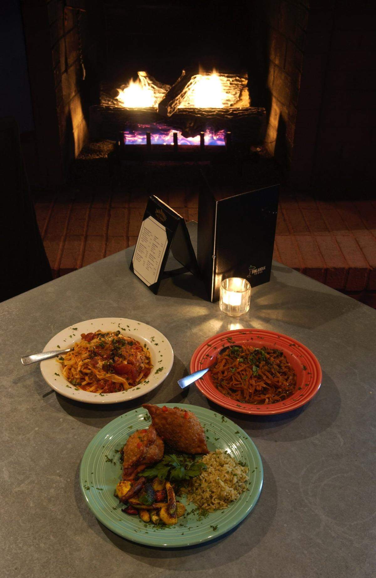 Clockwise from bottom, Brie and Wild Mushroom Empanada dinner, Linguine with Tomato and Herbs, and Lime Chile Pesto Linguine were some of the dishes at Ed and Fred’s Desert Moon in 2001.