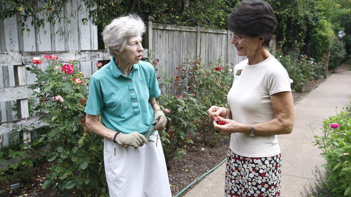 Resident Eileen Will, left, and administrator Ric McGee chatted in the cutting garden at Ashland Terrace retirement home in Lexington last week.