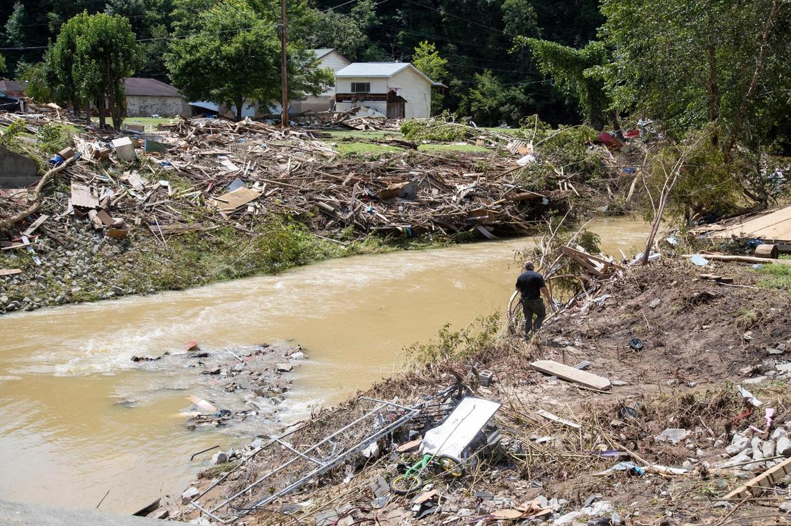 Search and rescue units look around Troublesome Creek Saturday for at least two people who are still missing after flooding swept through the area.