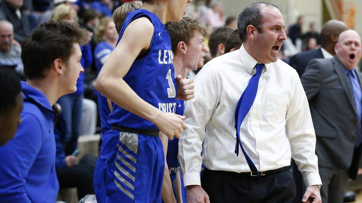 Lexington Christian head coach Nate Valentine cheered during the boys’ 43rd District semifinals against Lexington Catholic in February.