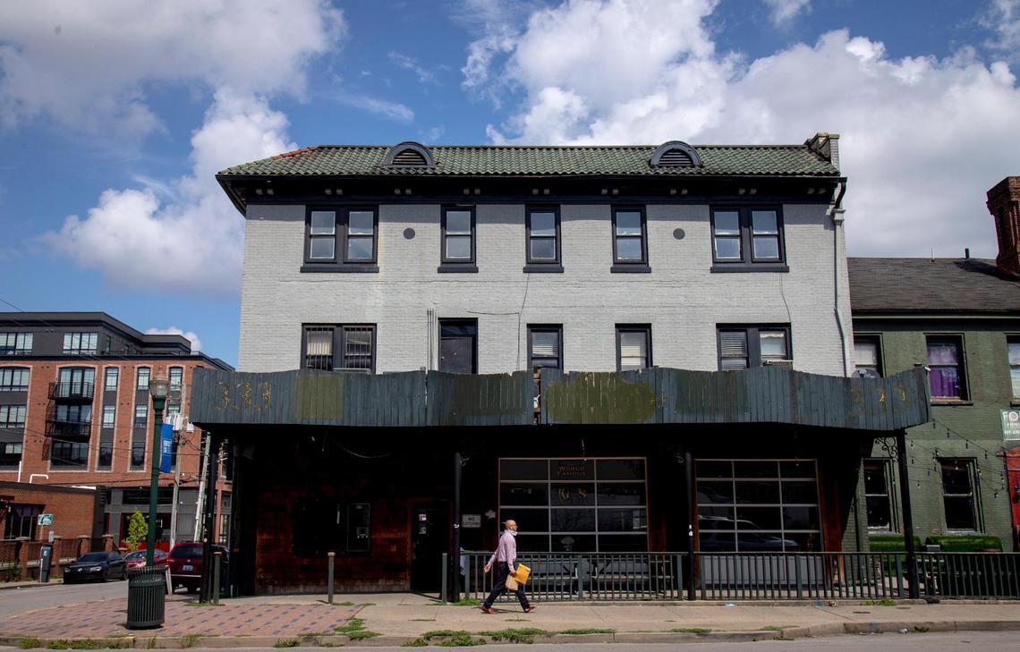 A man walks by the building that was the site of Two Keys Tavern for 66 years in Lexington, Aug. 3. The tavern filed for bankruptcy in July due to coronavirus-related closures and loss of revenue.