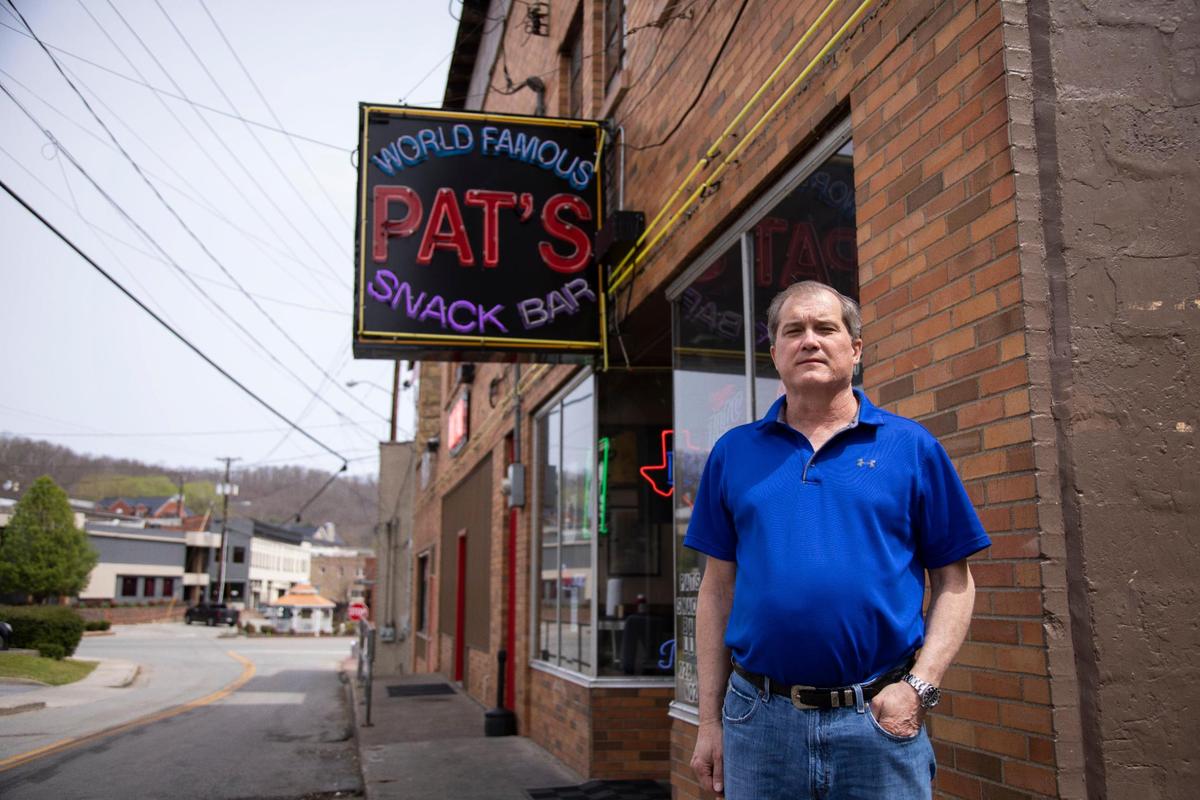 Pat’s Snack Bar owner Charles Stivers remembers coming in when he was young, he bought the bar in 2011 and added a kitchen out back and began serving burgers, hot ham and cheese sandwiches, chili buns and more in Manchester, Ky., Friday, April 15, 2022.