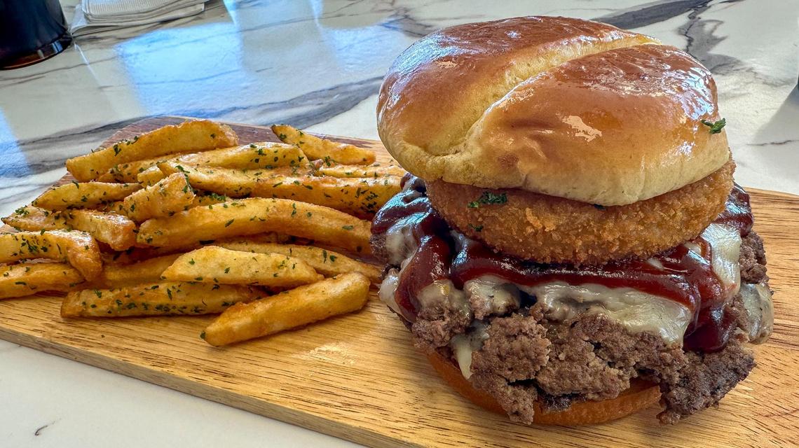 The We Be Grubbin’ burger at Bubba Grub, Oct. 27, 2024 in Nicholasville, Ky. The burger, served with french fries, to topped with bourbon barbecue sauce, house-made bourbon bacon jam, pepper jack cheese and a house-made onion ring on a toasted bun.