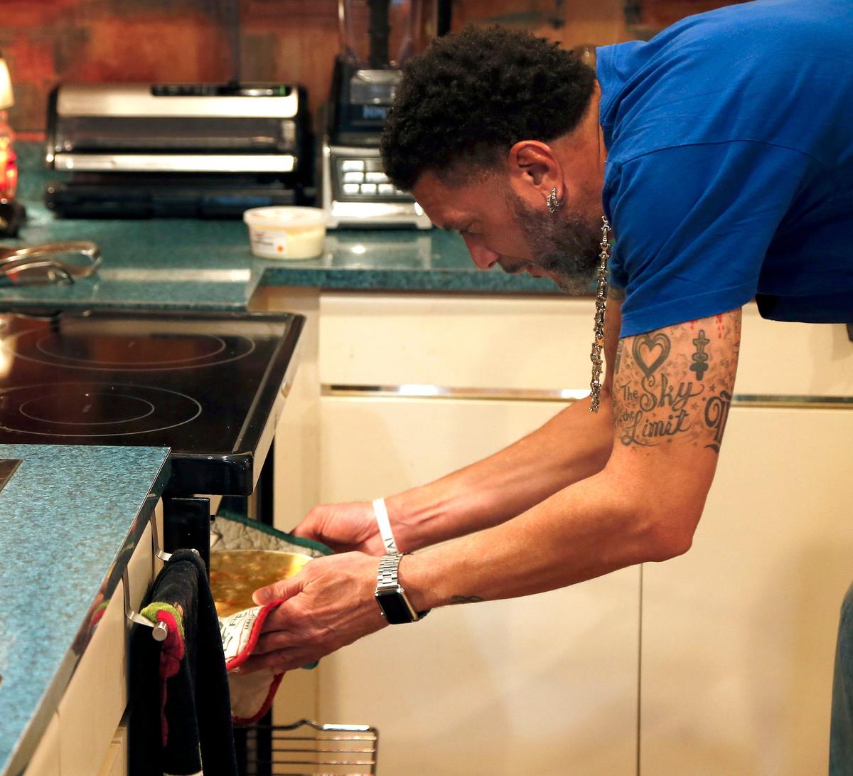 Sporting a tattoo that says “The Sky’s the Limit,” former University of Kentucky basketball player Kenny “Sky” Walker checked on his mac and cheese. He likes to give it a few minutes under the broiler to get that brown crust.