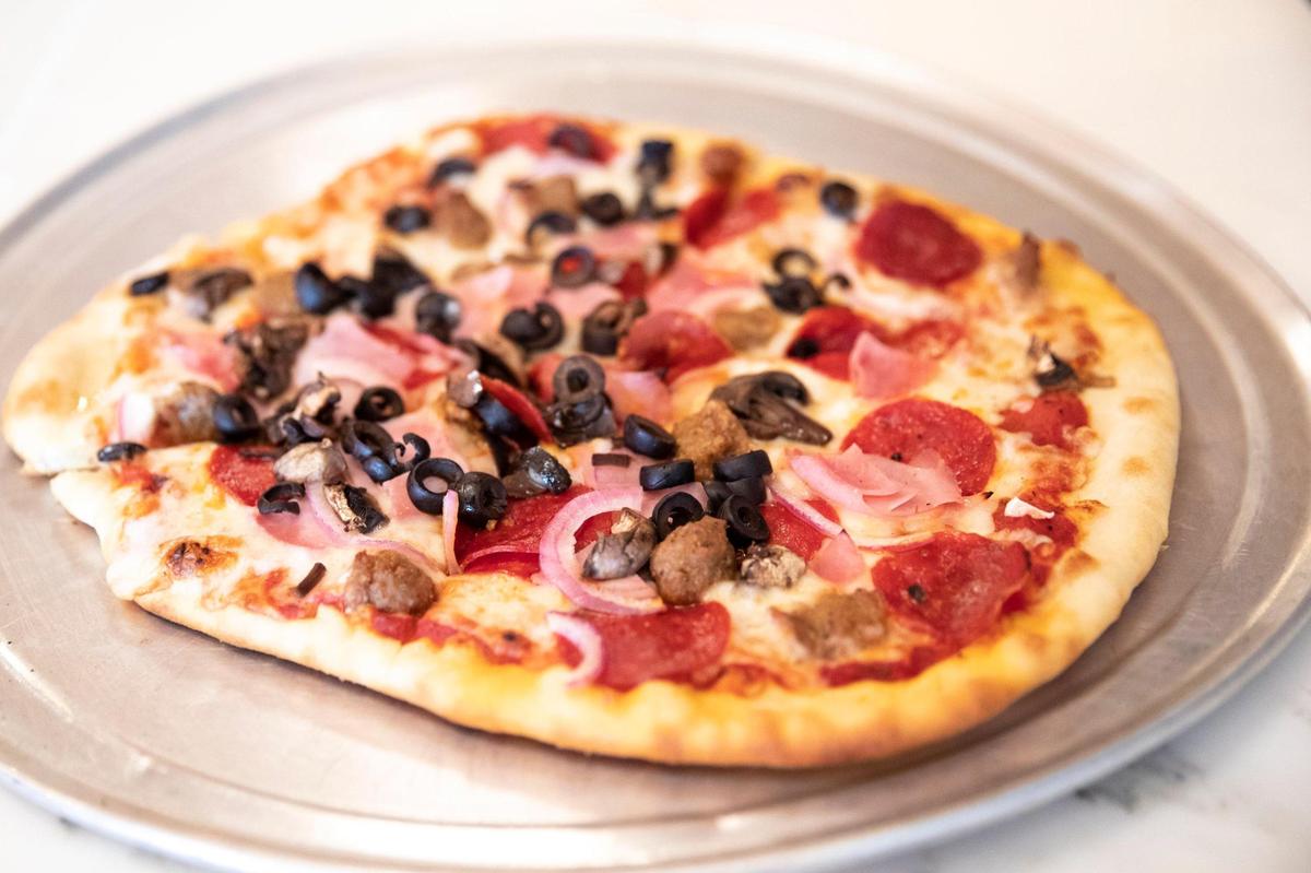 The Winchester pizza, including marina, Bacio mozzarella, pepperoni, ham, Italian sausage, onion, mushrooms and black olives at the Engine House Pub and Pizza Parlour.