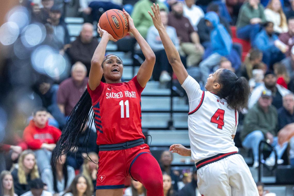Sacred Heart’s ZaKiyah Johnson (11) shoots over George Rogers Clark’s Jailenn Green (4). Johnson finished with 26 points Wednesday night.