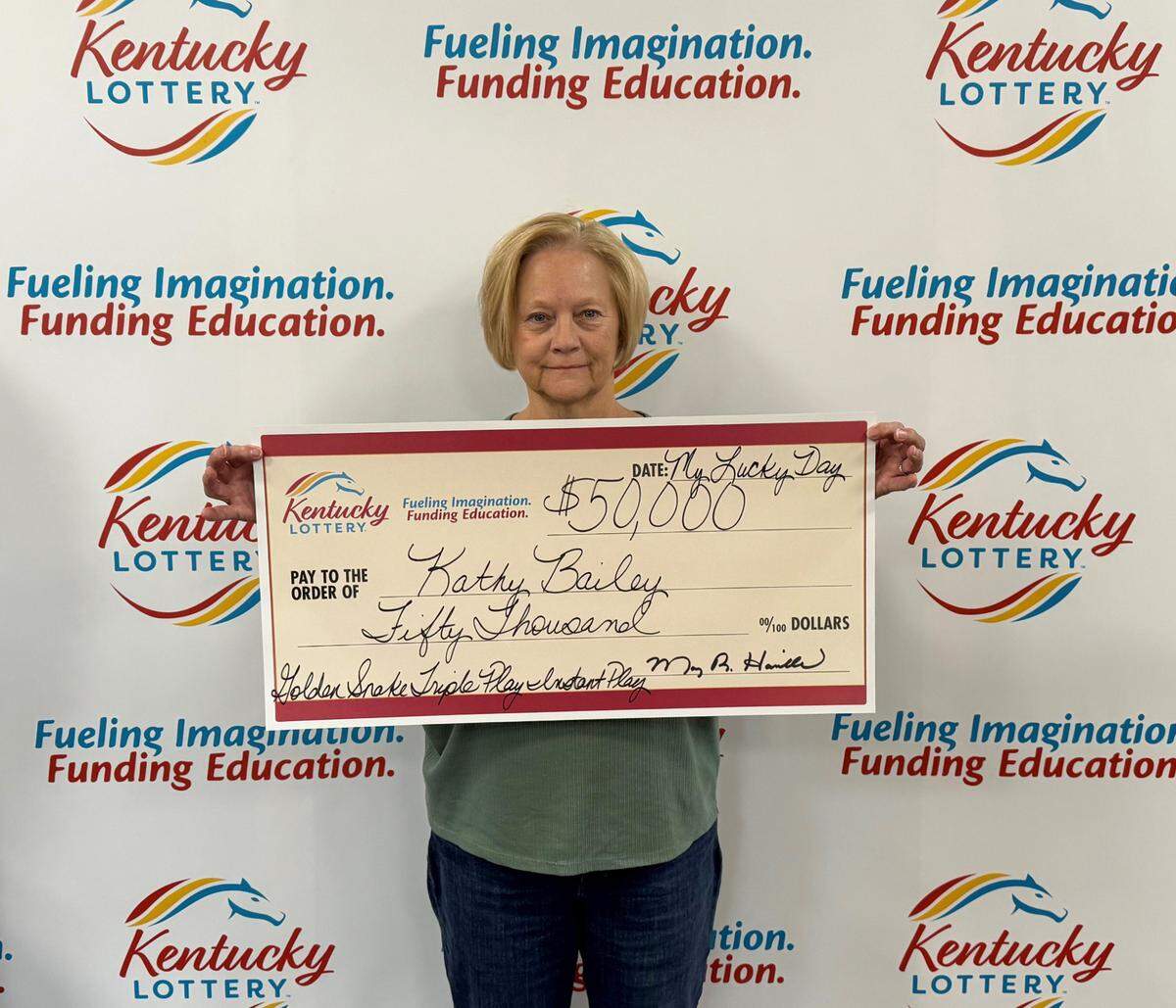 Kathy Bailey, of Lexington, poses with her Kentucky Lottery winnings.