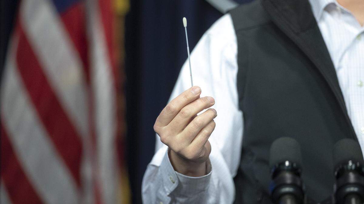Steven Stack, Kentucky Department for Public Health commissioner, demonstrates how swabs can be used to test for the novel coronavirus during a media conference at the state Capitol in Frankfort, Ky., on Sunday, April 19, 2020.