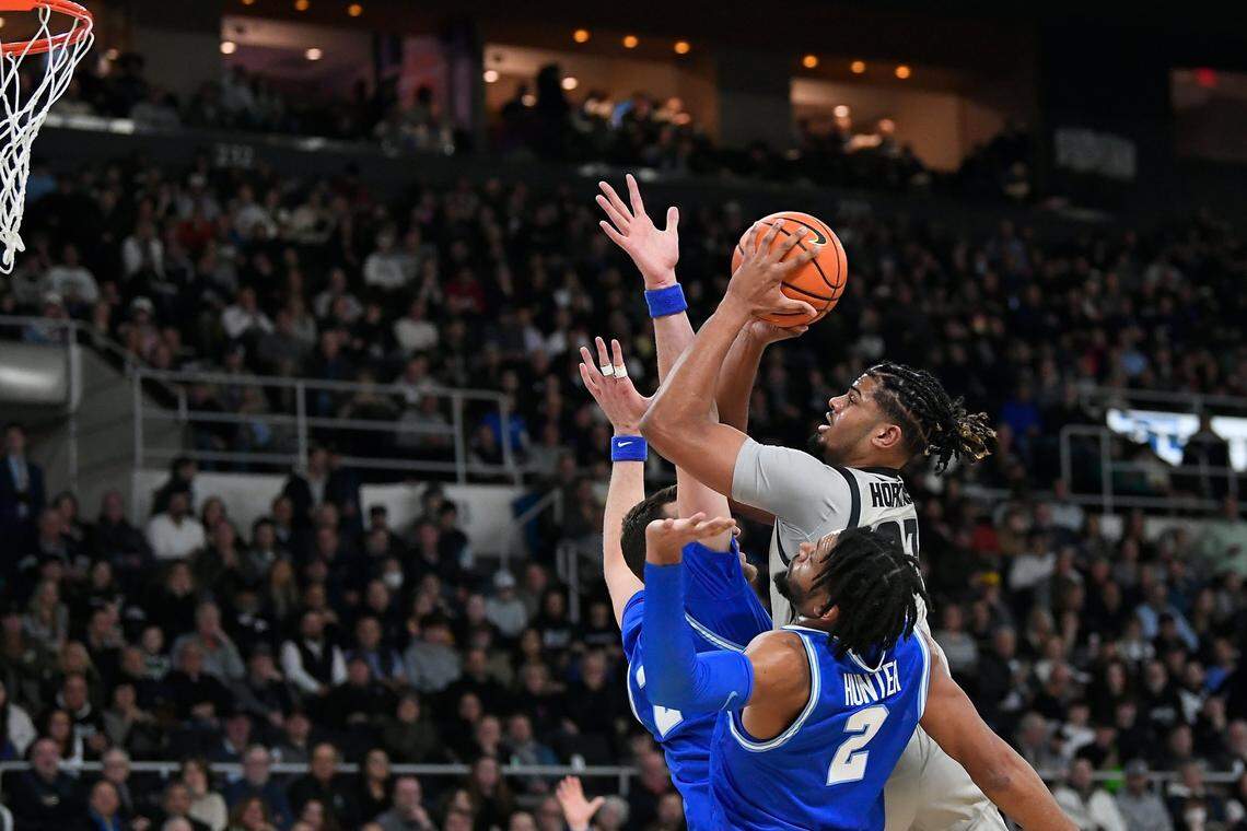 Providence forward Bryce Hopkins, top right, takes a shot against Xavier during the Big East Tournament.