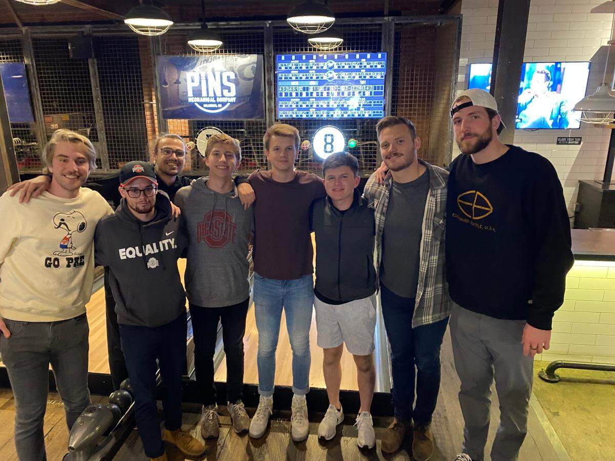 After a Bible study in his role as a Catholic missionary, Patrick Towles, second from right, organized a bowling outing.