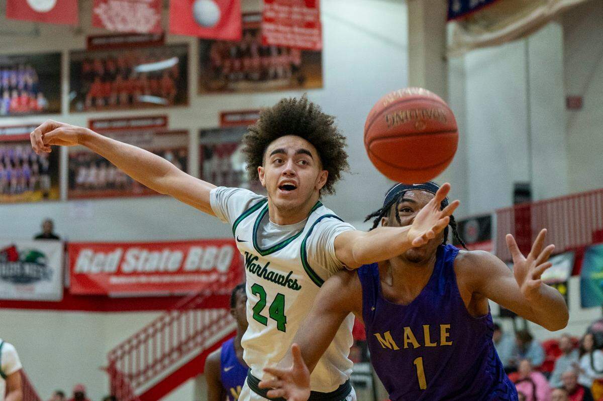 Great Crossing’s Malachi Moreno (24) and Male’s Keashawn Jordan (1) went after a loose ball during the Warhawks’ 65-63 win at Scott County High School in the Dan Cummins Classic.
