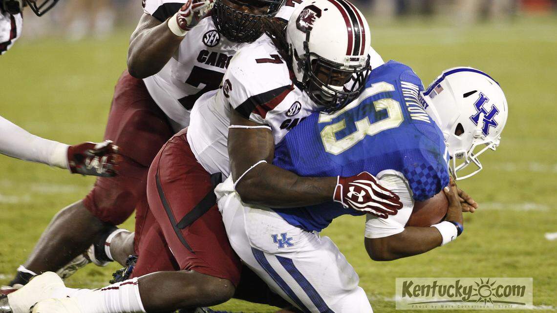 Kentucky quarterback Jalen Whitlow was sacked by South Carolina defensive end Jadeveon Clowney in September 2012 as the Gamecocks defeated Kentucky 38-17. Photo by Mark Cornelison | Staff