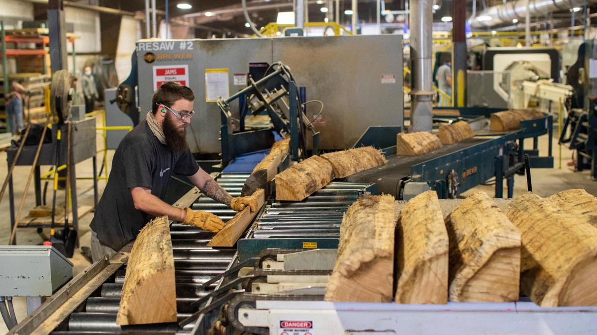 Workers turn white oak logs into staves for 53-gallon bourbon barrels at Robinson Stave Mill in Laurel County on Dec. 13, 2021. The staves are dried for nine-twelve months before they are crafted into barrels. The need for bourbon barrels may be creating a shortage of white oak trees.
