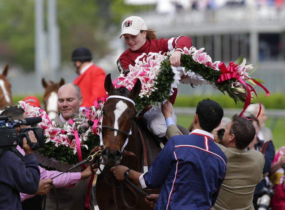 Jockey Rosie Napravnik placed the garland of lilies across Untapable after winning the 140th running of the Kentucky Oaks on May 2, 2014, at Churchill Downs.