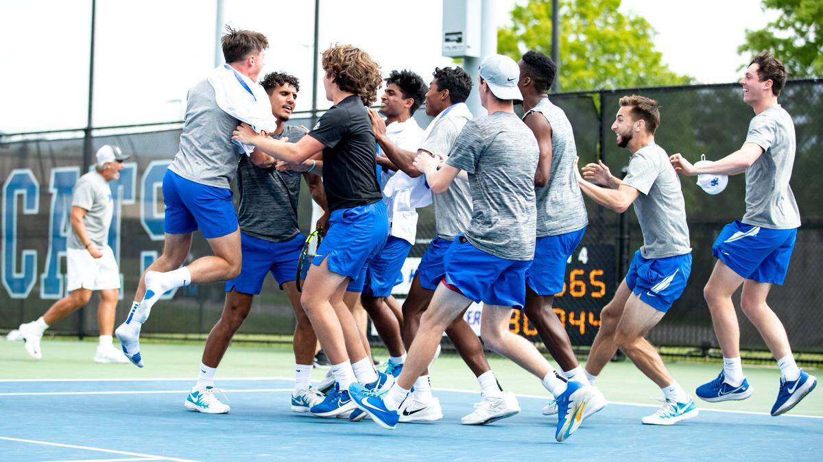 Kentucky’s men’s tennis team celebrates its second-round NCAA Tournament victory against Northwestern on Saturday at the Hilary J. Boone Tennis Complex in Lexington.