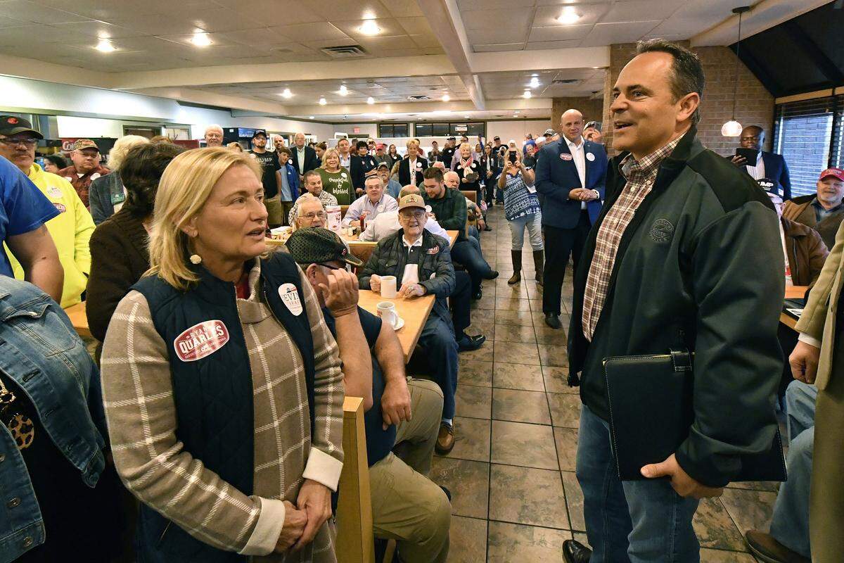 Kentucky Governor and Republican candidate Matt Bevin, right, talks with supporters during a stop of his bus tour in Elizabethtown, Ky., Friday, Oct. 25, 2019. (AP Photo/Timothy D. Easley)