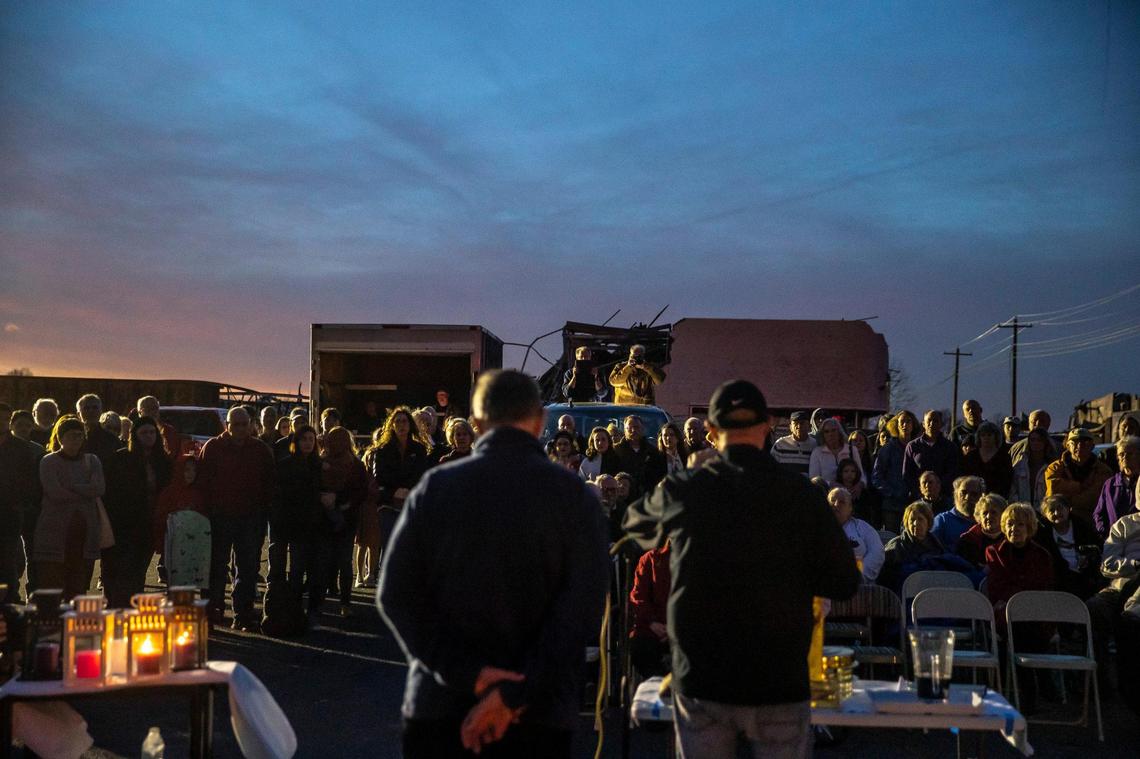 Members of Mayfield First Presbyterian Church and Mayfield First Christian Church gather in an empty lot between their destroyed church buildings for a joint Christmas Eve service in Mayfield. A tornado devastated the community on Dec. 10.